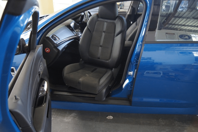 Swivel seat exciting from passenger side of blue car