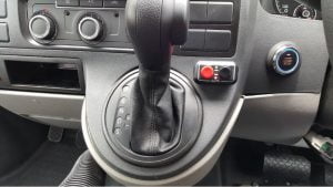 Image of car gear stick with Fadiel Hand Brake buttons, red and black, to the right
