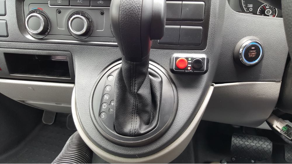 Image of car gear stick with Fadiel Hand Brake buttons, red and black, to the right
