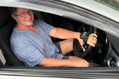 Tonya shown using her new hand controls that enable her to drive with neuropathy
